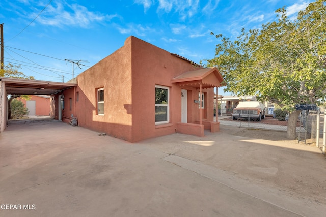 view of property exterior featuring a carport