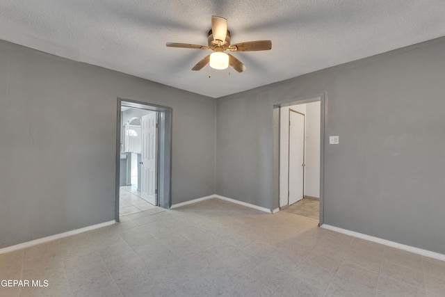 spare room with ceiling fan and a textured ceiling