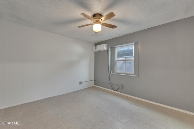 unfurnished room featuring an AC wall unit, ceiling fan, and a textured ceiling