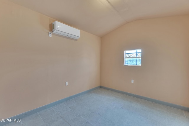 spare room with a wall unit AC and lofted ceiling