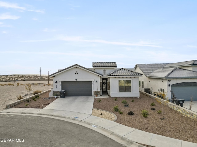 view of front of home featuring central air condition unit and a garage