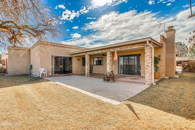 back of house featuring a yard and a patio area