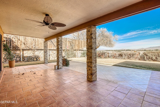 view of patio with a mountain view and ceiling fan