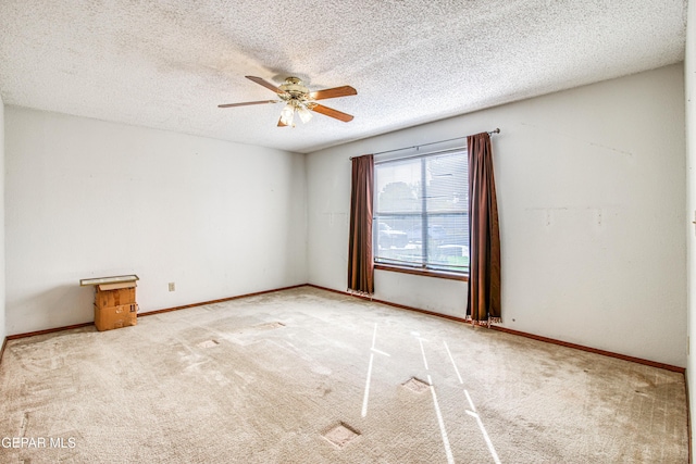 empty room featuring light carpet, a textured ceiling, and ceiling fan