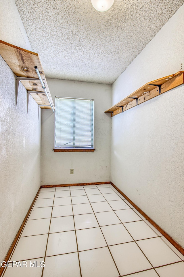 spacious closet with light tile patterned floors