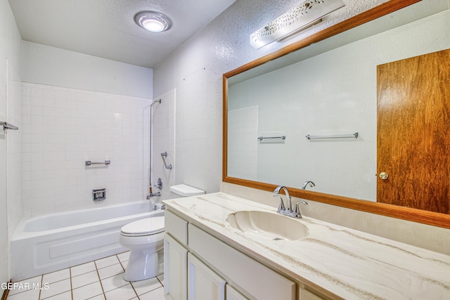 full bathroom featuring vanity, a textured ceiling, tiled shower / bath, tile patterned floors, and toilet