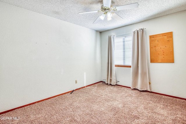 carpeted empty room featuring ceiling fan and a textured ceiling