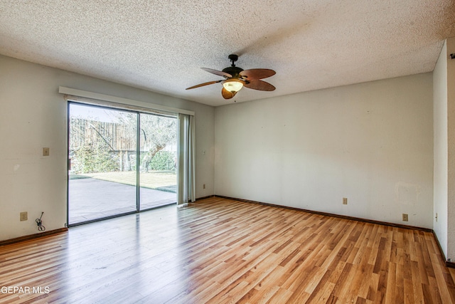 empty room featuring ceiling fan, light hardwood / wood-style floors, and a textured ceiling