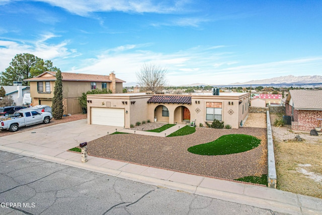 view of front of house featuring a garage and a mountain view