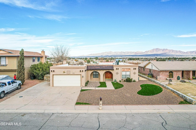 view of front of home with a garage and a mountain view