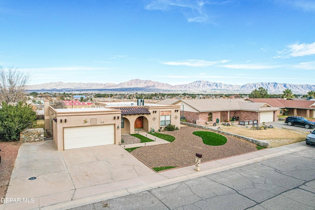 view of front of home with a garage and a mountain view