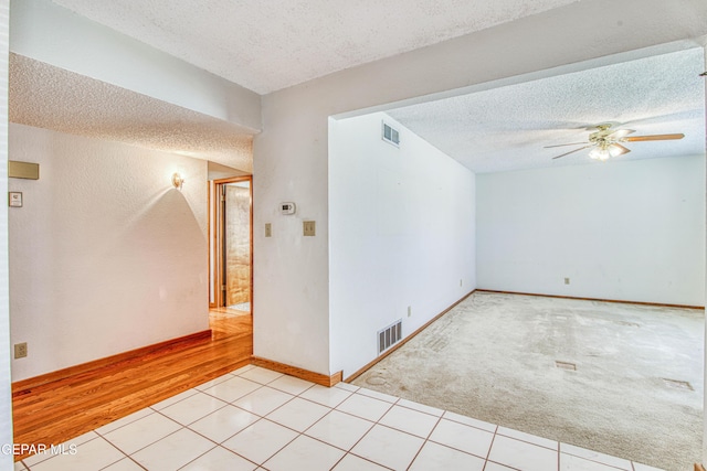 spare room with ceiling fan and a textured ceiling