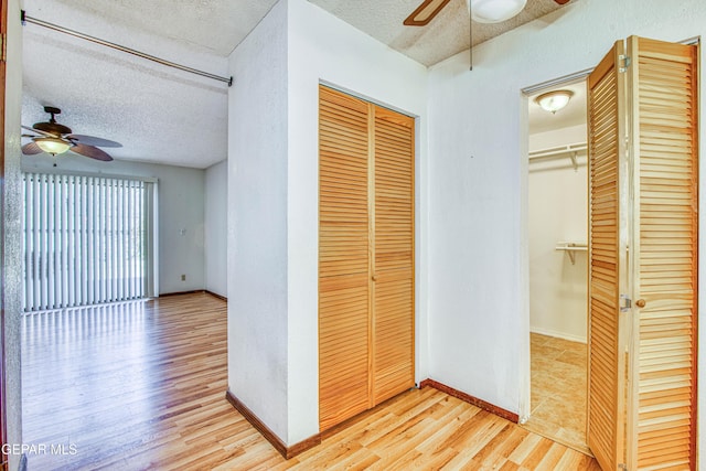 interior space with a textured ceiling and light wood-type flooring