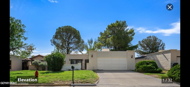 view of front of property with a garage and a front lawn