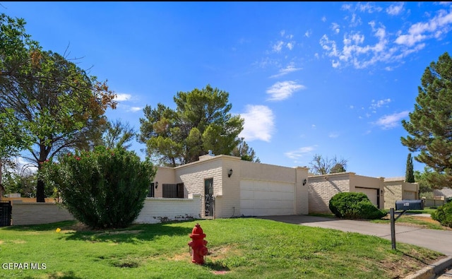 single story home with a garage and a front yard