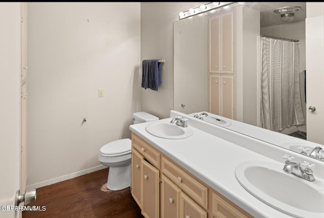 bathroom with vanity, wood-type flooring, and toilet