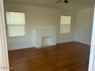 unfurnished living room with dark hardwood / wood-style floors