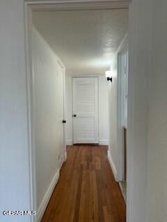 hallway with dark wood-type flooring