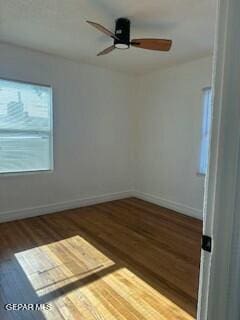 empty room featuring dark hardwood / wood-style flooring