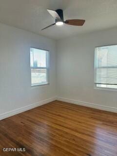 empty room featuring ceiling fan and dark hardwood / wood-style floors