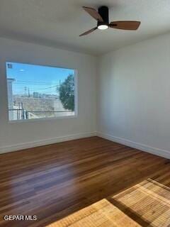 unfurnished room with ceiling fan and dark hardwood / wood-style flooring