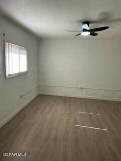 spare room with ceiling fan and dark hardwood / wood-style floors