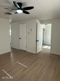 spare room with hardwood / wood-style floors