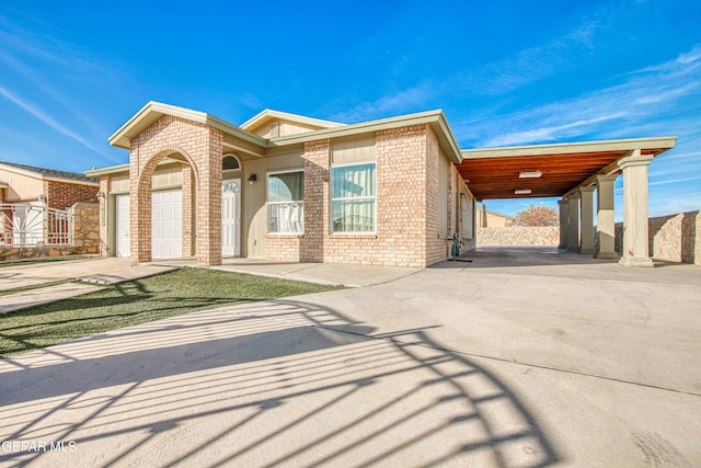 view of front of property featuring a garage and a carport