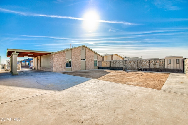 view of side of home with a carport