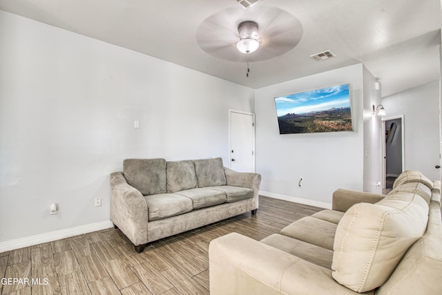 living room featuring hardwood / wood-style flooring and ceiling fan