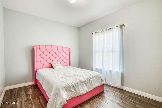 bedroom with dark wood-type flooring