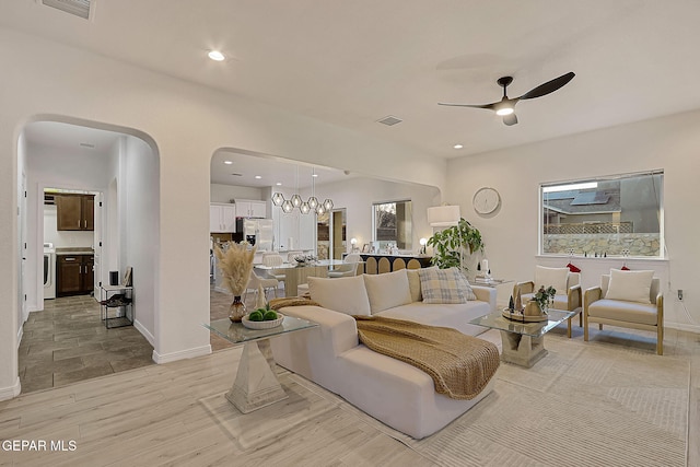 living room featuring washer / clothes dryer and ceiling fan