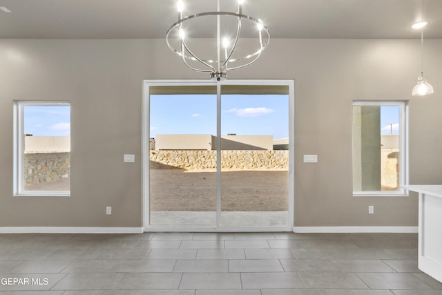 unfurnished dining area with an inviting chandelier