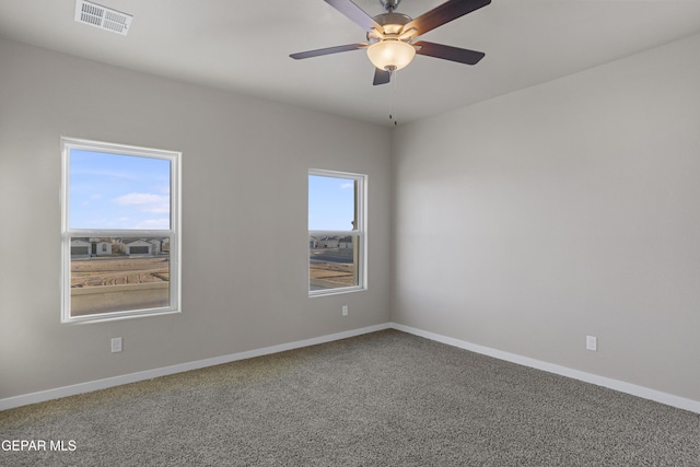 carpeted empty room featuring ceiling fan