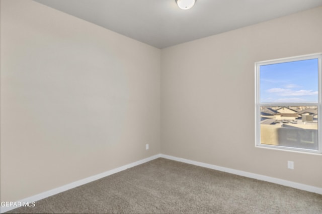 unfurnished room featuring light colored carpet