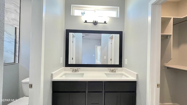 bathroom featuring vanity and toilet