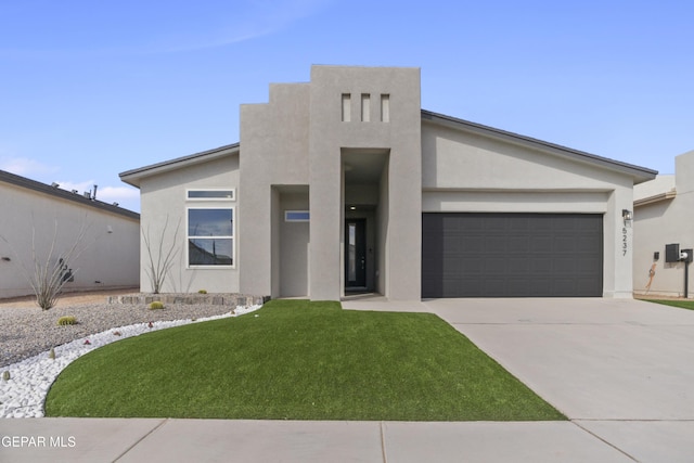 view of front of home with a garage and a front yard