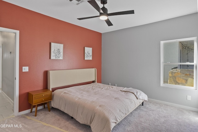 bedroom featuring light carpet and ceiling fan