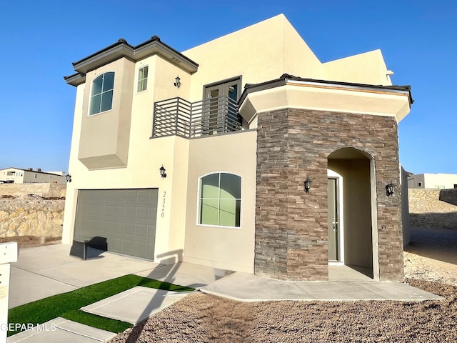 view of front of home with a balcony and a garage