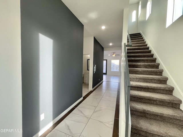 stairway with ceiling fan