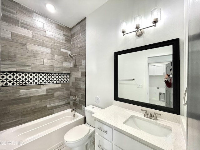 full bathroom featuring toilet, tiled shower / bath combo, and vanity