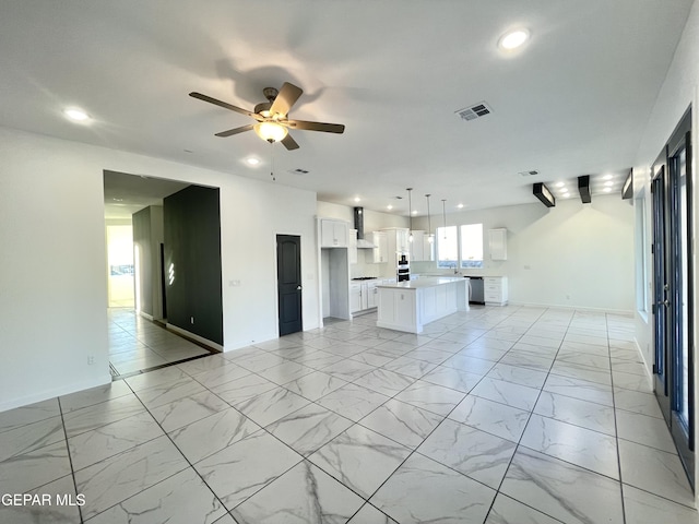 unfurnished living room with ceiling fan