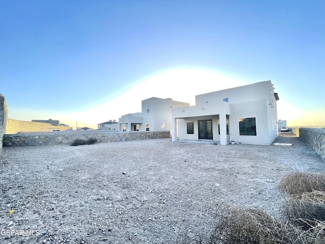 view of back house at dusk