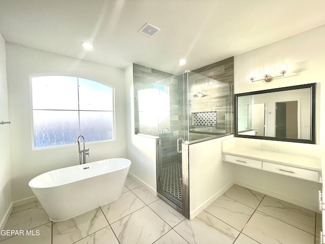 bathroom with vanity and independent shower and bath