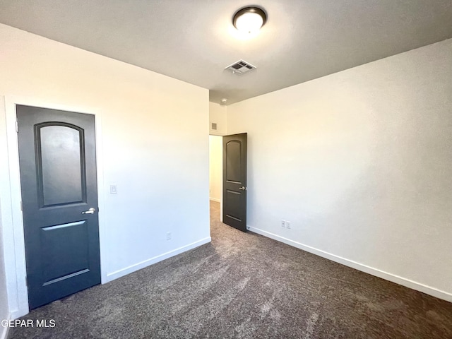 unfurnished bedroom featuring dark colored carpet