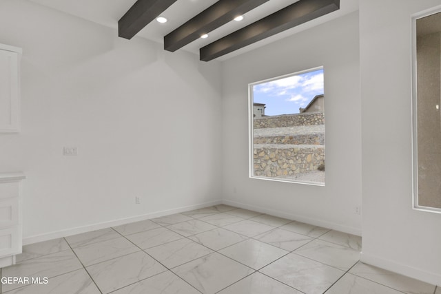 empty room featuring beam ceiling