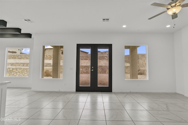 foyer entrance with french doors and ceiling fan