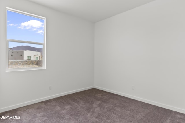 empty room with dark carpet