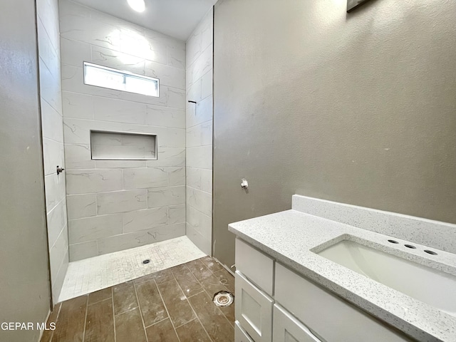 bathroom featuring vanity and tiled shower