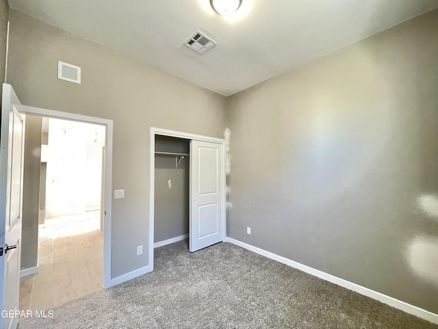 unfurnished bedroom featuring a closet and carpet